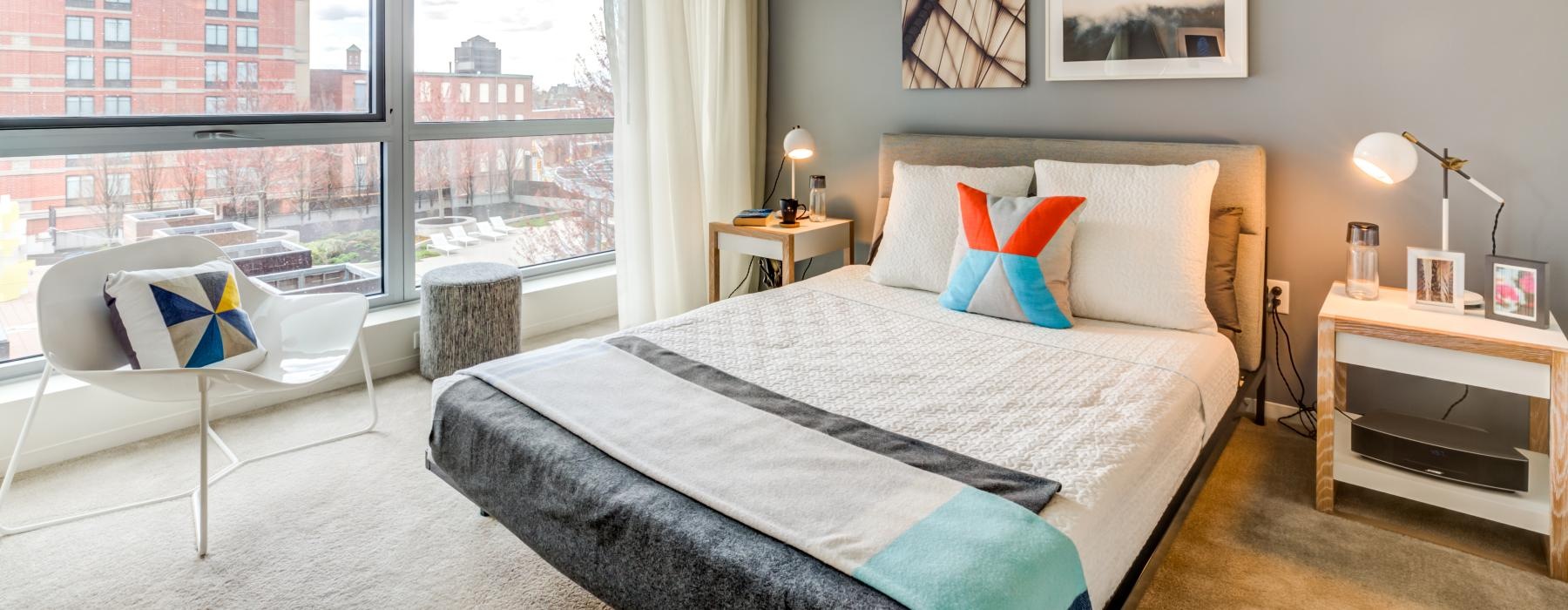 a bedroom with a large window