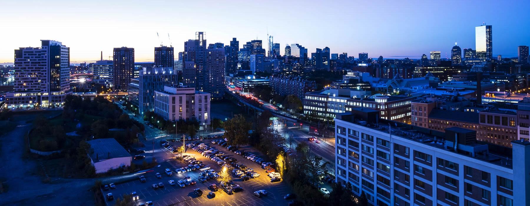 a city with buildings and streets at night